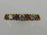 An 18ct yellow gold ruby and diamond seven stone ring.