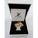 A Swarovski basket brooch, within retail box.