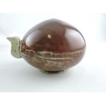 A sang de boeuf glazed water dropper, of flattened globe form with narrow spout and breather hole,