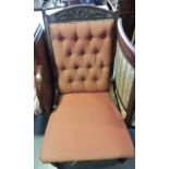 A late Victorian mahogany armchair, upholstered buttoned red fabric on ring turned legs,