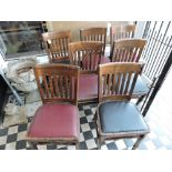 A set of seven beech dining chairs with red/black leatherette seats