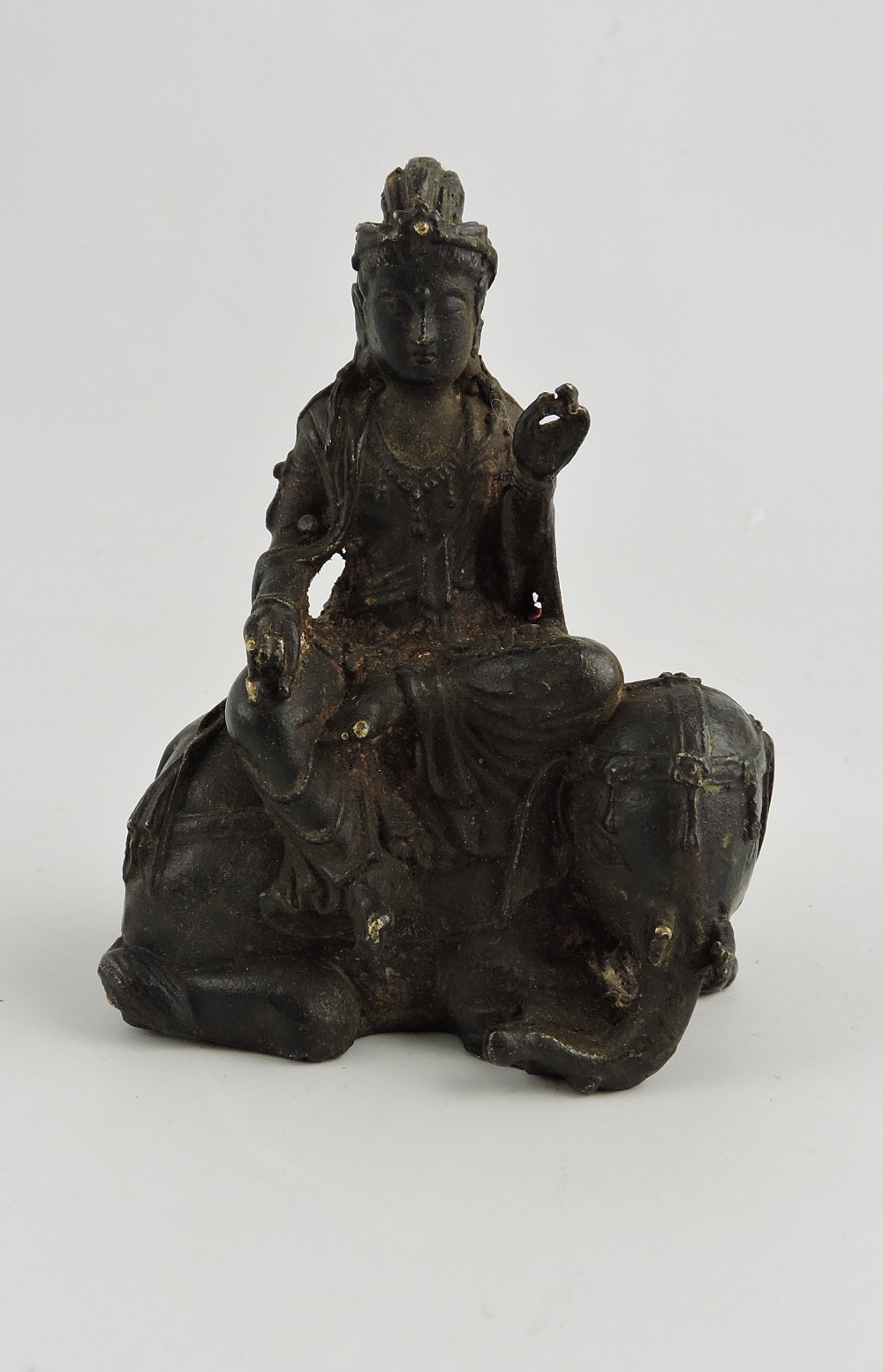 A Chinese cast bronze figure of guylan, seated upon an elephant, H. 8cm.