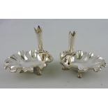 A pair of silver plated posy vases/ pen holders, above shell shaped bowls,