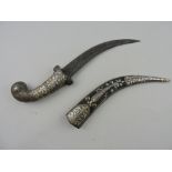 A Persian style dagger with a curved blade, the handle and scabbard decorated with foliage, L. 21cm.