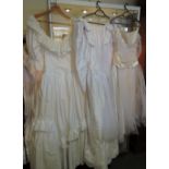 Three vintage white wedding dresses circa 1980 and a white/pink bridesmaid dress.