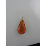 An amber pendant with an insect inclusion and yellow metal mount, 10.7g.