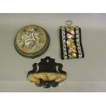 A Victorian ebonised wall shelf, semi-circular with a gros-point pendent apron, H.