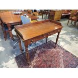 A mid Victorian mahogany side table with three quarter gallery over two drawers on turned tapered