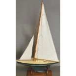 An early 20th century pond yacht, Bermuda rig with green hull, white boot-line and deck,