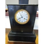 A Victorian black slate mantel clock with 8 day brass movement striking on a bell,