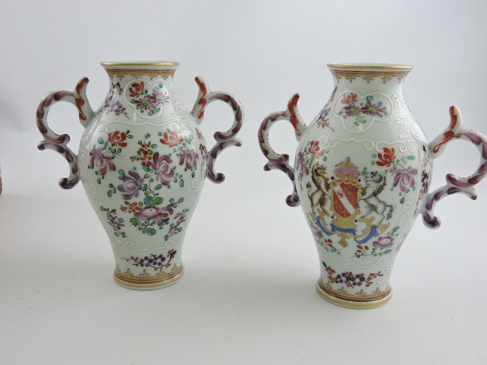 A pair of Chinese armorial vases, of baluster form with twin handles, H. 13cm, (2).