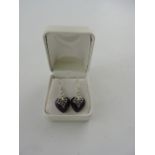 A pair of amethyst and white metal mounted ear pendants, in the form of hearts with pierced bails,
