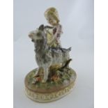 A continental porcelain figure group, a young girl with a goat, on a naturalistic oval base, H.