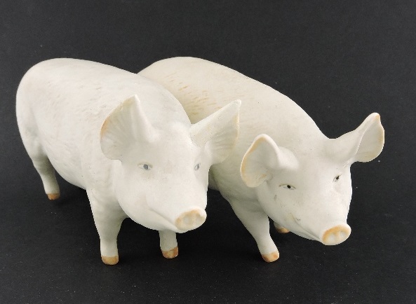 A pair of white Beswick pigs, boar and sow, L. 17cm.