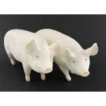 A pair of white Beswick pigs, boar and sow, L. 17cm.