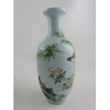 A baluster shaped famille rose vase decorated on a pale blue ground,