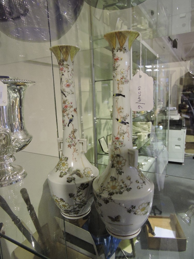 A pair of early 20th Century Japanese porcelain vases with elongated necks,