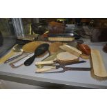 A collection of Victorian and later hairbrushes, hand mirrors,