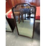 A pair of rectangular mahogany framed wall mirrors with arched plates,