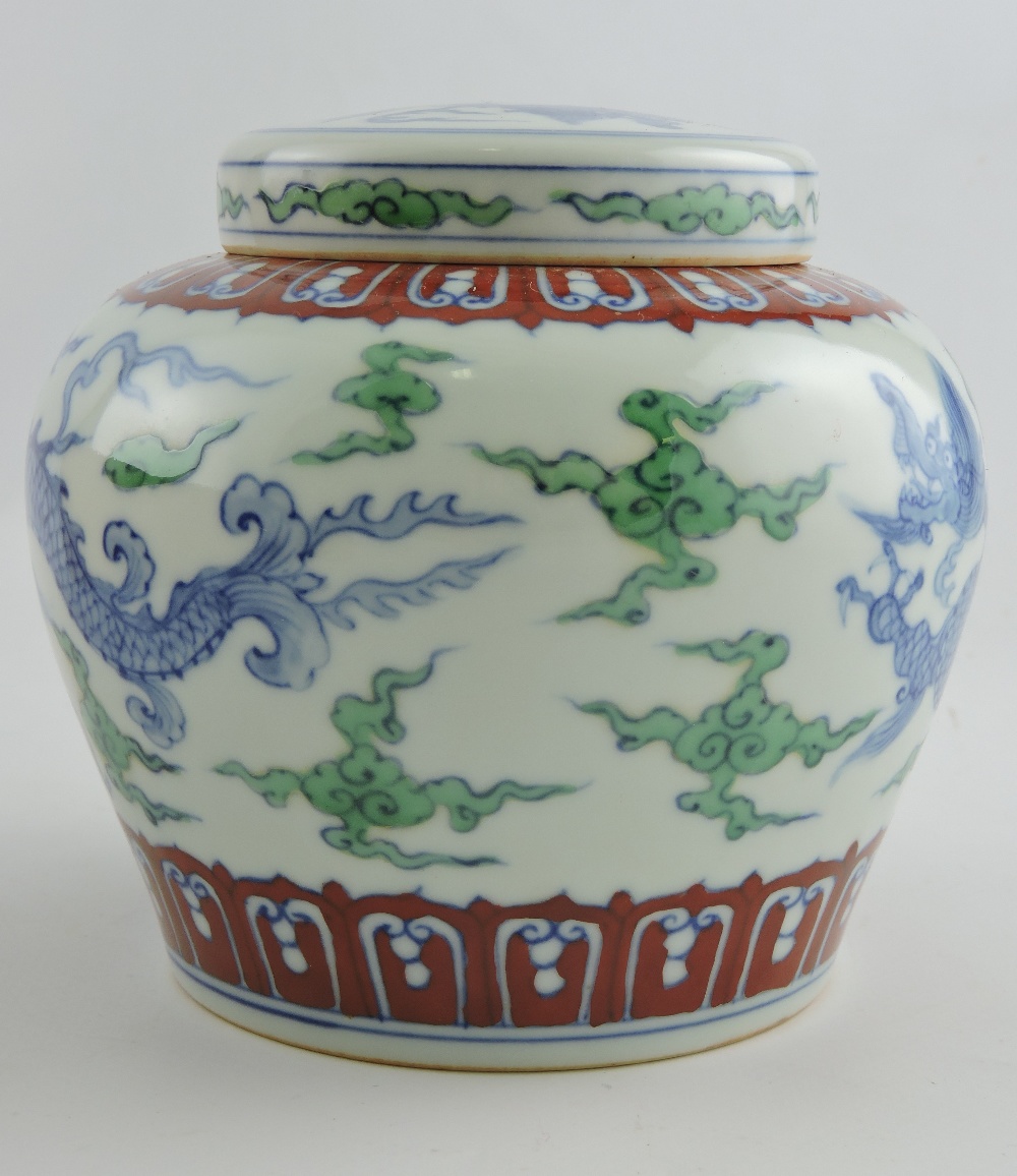 A Doucai style ginger jar and cover decorated with dragons among clouds, H. 12cm.