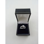 A cubic zirconia and white metal dress ring, stamped 925, together with a half hoop eternity ring,