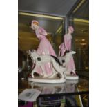 A pair of Continental Art Deco style pottery figures of elegant ladies of Borzoi,