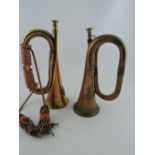 A copper and brass bugle, together with another bearing an armorial, (2).