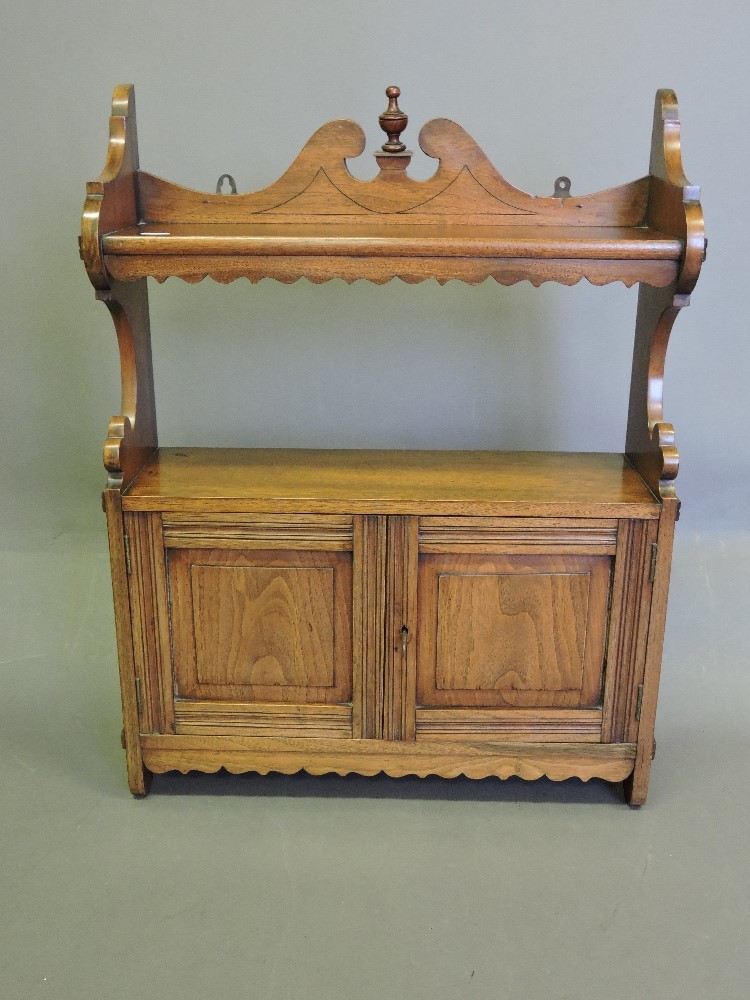 A late Victorian walnut hanging wall cabinet,