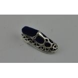 A small Victorian style silver pincushion modelled as a ladies shoe