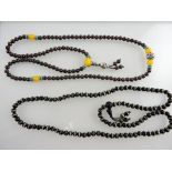 A garnet necklace of uniform beads together with an agate necklace, (2).