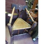 A 19th Century turned oak chair with chip carved back over a triangular seat on cylindrical under