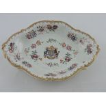 A 19th century Chinese armorial plate, oval with floral vignettes and tube-lining, W.