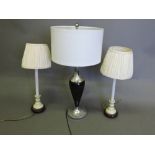 A contemporary table lamp, of ebonised baluster form with chrome mounts,