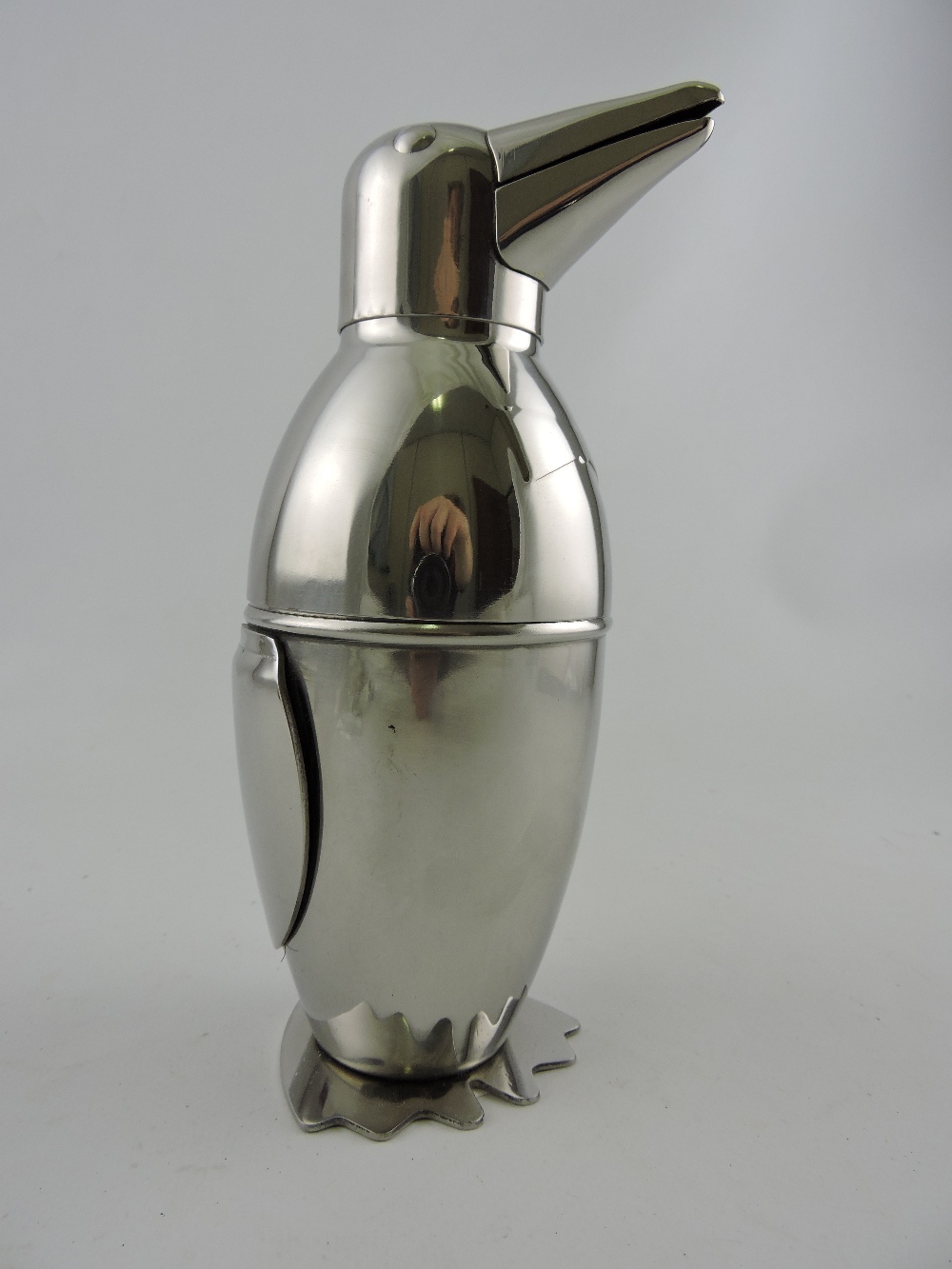 A bright metal cocktail shaker in the form of a penguin, H. 20cm.