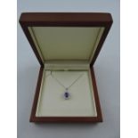 A tanzanite and diamond pendant, the central stone approx. 1.