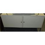 An industrial style cream metal two door low cabinet,