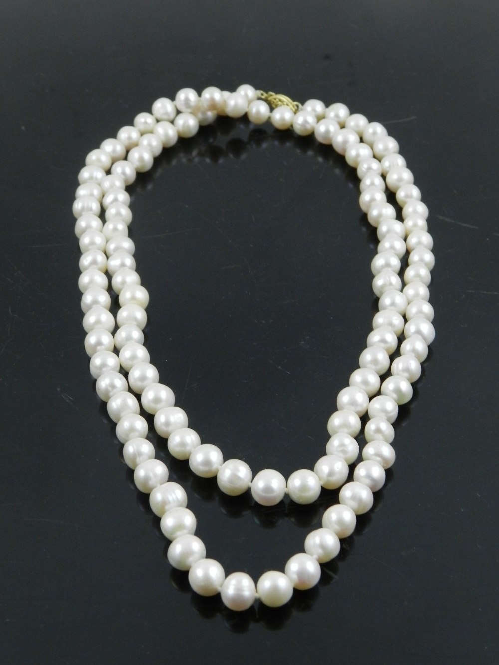 A 36 inch string of South Sea AAA pearls, with a 14 carat yellow gold clasp.