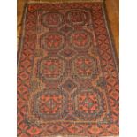 A Persian Balouch rug, having two rows of elephant pad motifs to centre, multi-bordered and fringed.