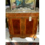 In the Neoclassical taste, a satinwood and ormolu mounted side cabinet, marble topped,
