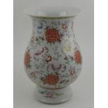 A Chinese porcelain vase, decorated in the famille rose palette with scrolling foliage,