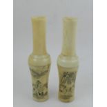 A pair of Japanese bone vases, decorated with figural scenes.