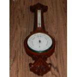 A 20th century oak cased wheel barometer.