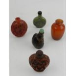 A collection of five Chinese snuff bottles, to include a green hardstone snuff bottle, and others.