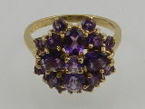 A 9 carat yellow gold and amethyst cluster ring.