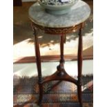 In the Neoclassical taste, a mahogany and ormolu mounted occasional table, marble topped. H.70cm.