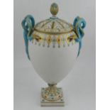 A Continental porcelain urn and cover, having handles modelled as gilt and turquoise snakes,