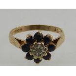 A 9 carat yellow gold, diamond and sapphire floral cluster ring.