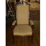 A late 19th / early 20th century French oak armchair, upholstered in a cream fabric,