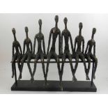 After Giacometti, a figural sculpture of figures sitting on a bench. L.