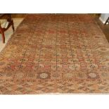 A red ground Turkoman carpet, the centre with multi elephant pad medallions, within many borders,